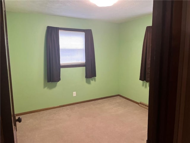 empty room with light carpet and baseboards