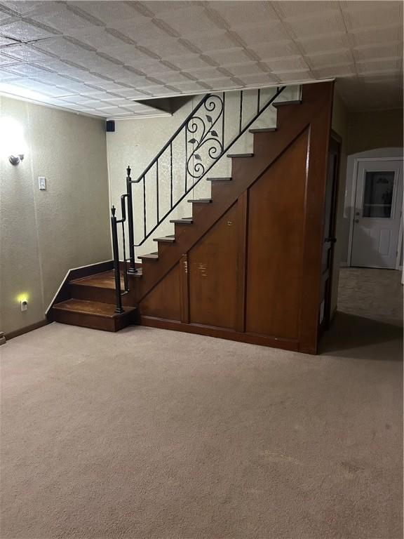 interior space with carpet flooring and baseboards