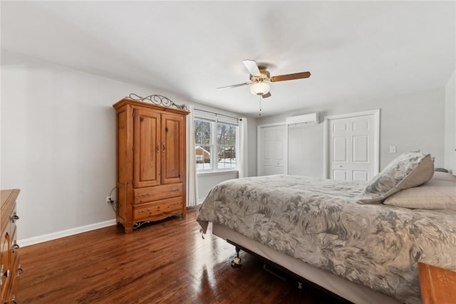 bedroom with a ceiling fan, wood finished floors, baseboards, and a wall mounted AC