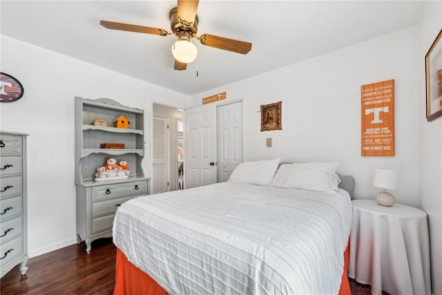 bedroom featuring a ceiling fan, dark wood-style flooring, a closet, and baseboards