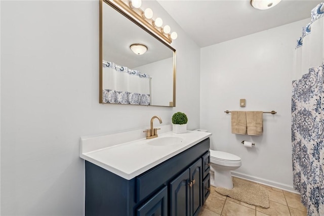 full bath with toilet, tile patterned flooring, baseboards, and vanity