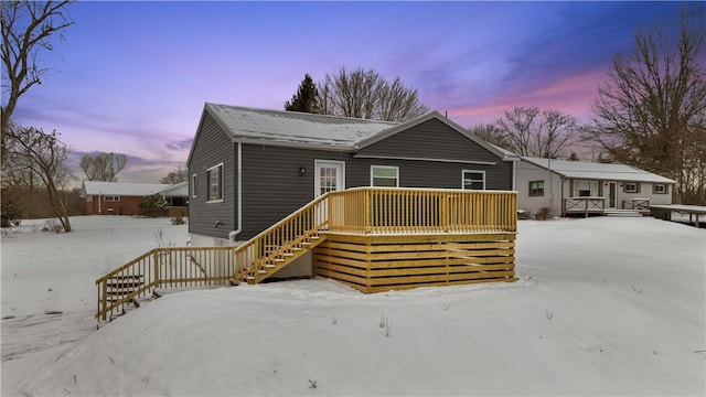 view of front of property featuring stairway and a wooden deck