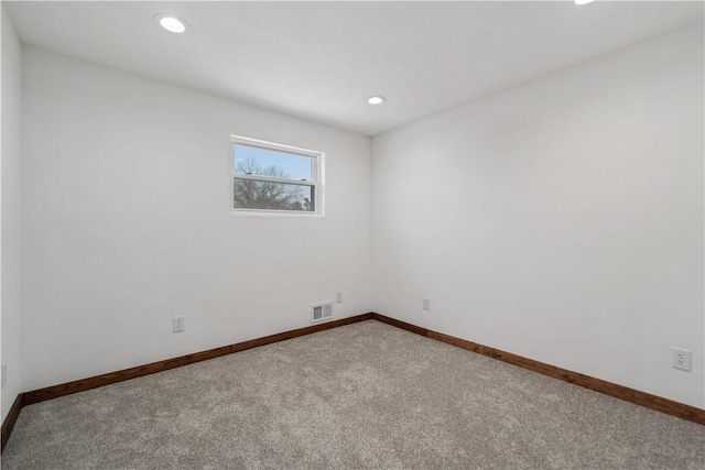 unfurnished room with carpet floors, baseboards, visible vents, and recessed lighting