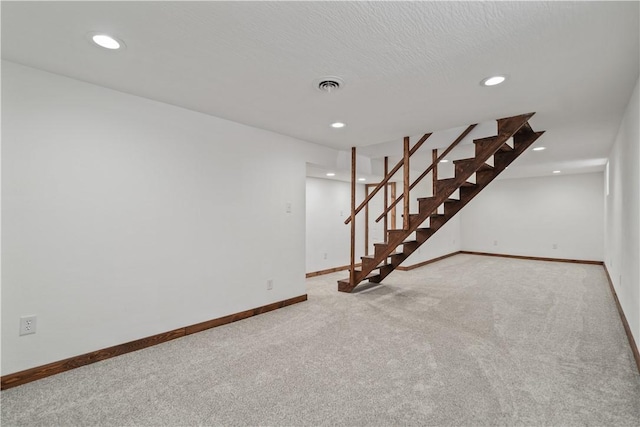 unfurnished room featuring recessed lighting, light colored carpet, visible vents, baseboards, and stairs