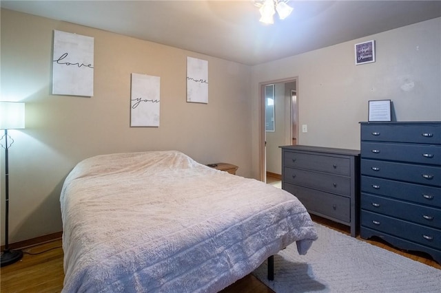 bedroom featuring wood finished floors