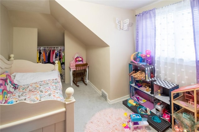 carpeted bedroom featuring visible vents, baseboards, and a closet