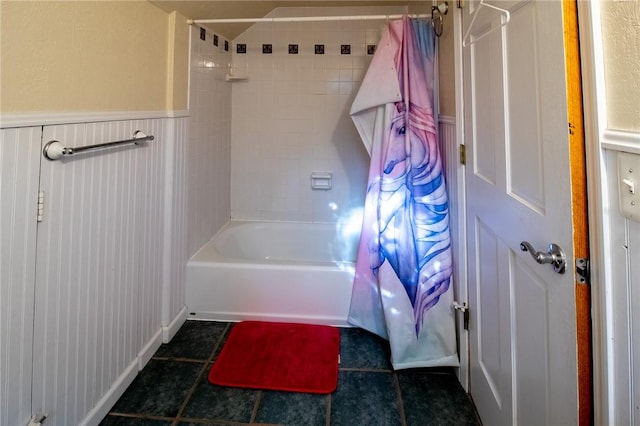 bathroom featuring shower / bath combo, tile patterned flooring, and wainscoting