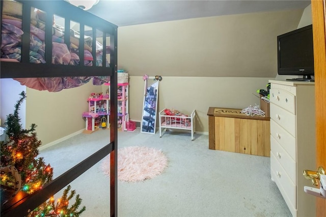 bedroom featuring light colored carpet, vaulted ceiling, and baseboards