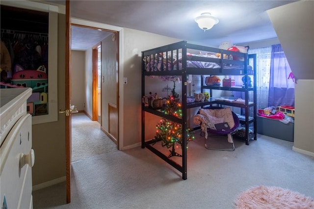 bedroom with light carpet and baseboards