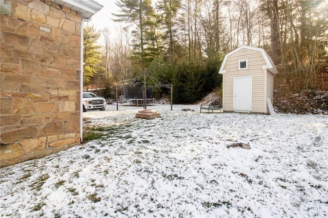 snowy yard with a trampoline