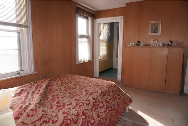 carpeted bedroom with wooden walls