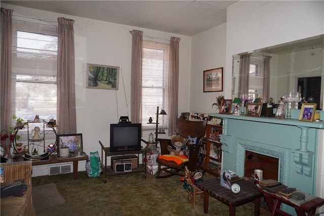 interior space featuring carpet floors, visible vents, and a fireplace