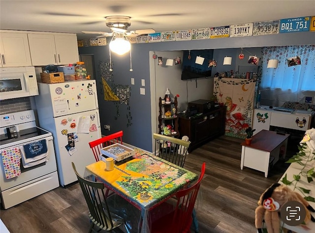 kitchen featuring dark wood-type flooring, white appliances, white cabinets, and a ceiling fan