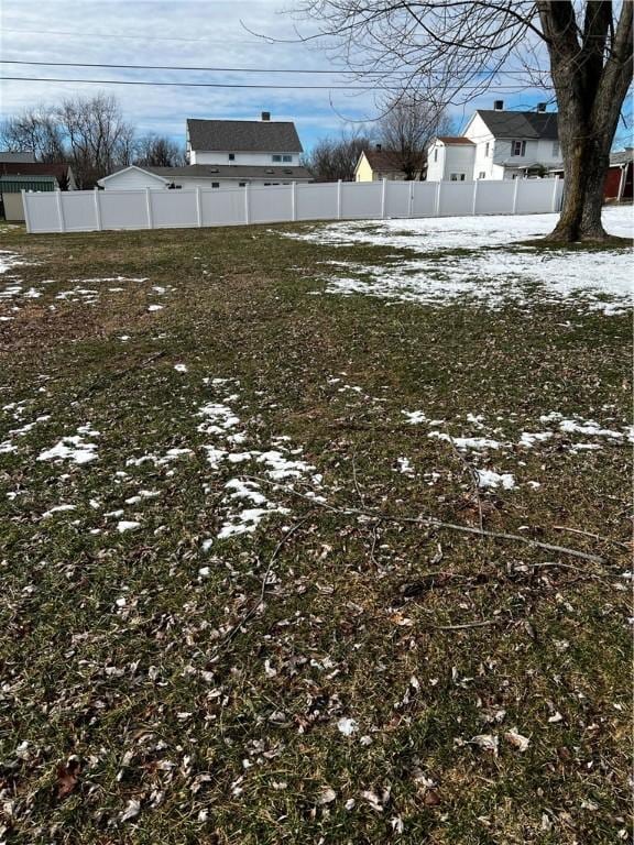 yard layered in snow with fence