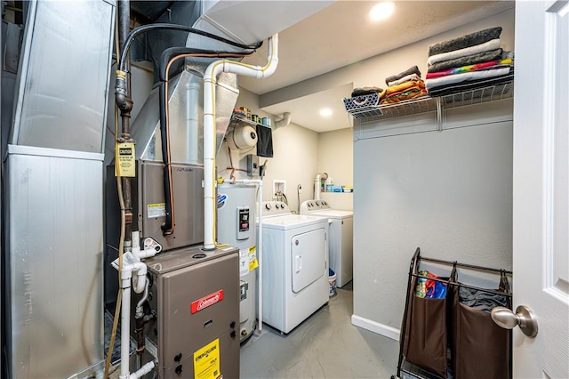 washroom with laundry area, water heater, and independent washer and dryer