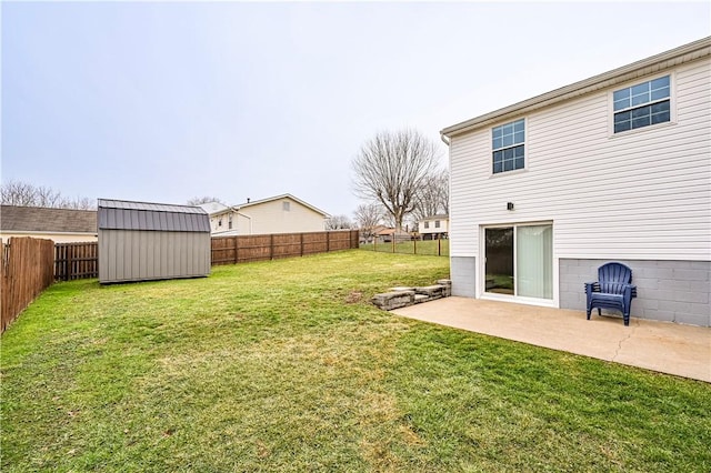 view of yard with an outbuilding, a patio, a shed, and a fenced backyard