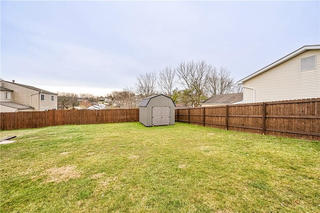 view of yard with a storage shed, an outbuilding, and a fenced backyard