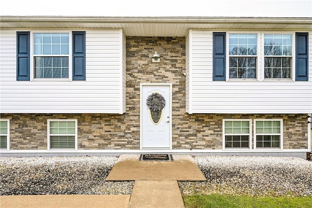 property entrance featuring stone siding