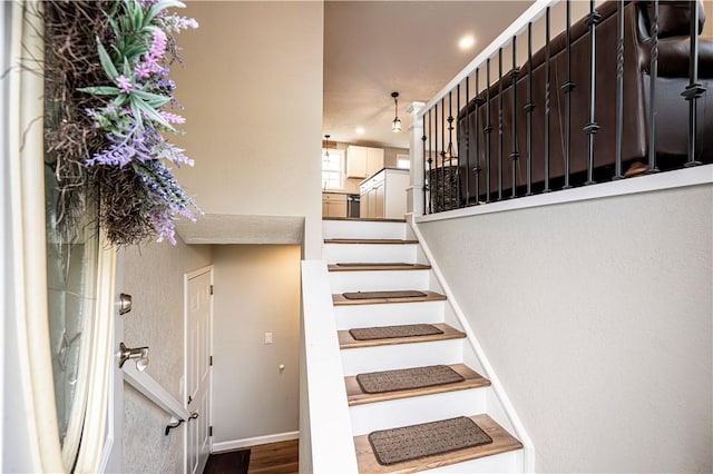 stairs with baseboards and wood finished floors