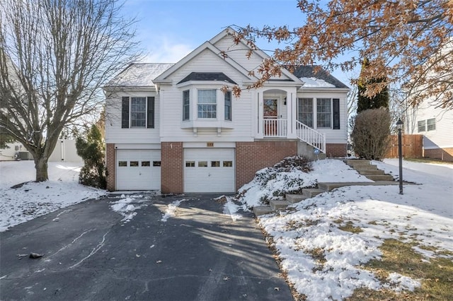 view of front of house featuring a garage, brick siding, and driveway