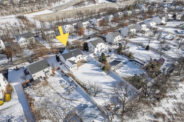 snowy aerial view featuring a residential view