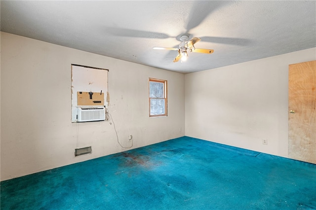 empty room with carpet floors, cooling unit, a textured ceiling, and a ceiling fan