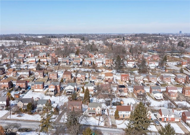 snowy aerial view with a residential view