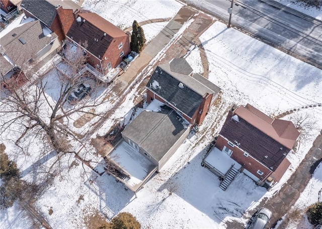 snowy aerial view with a residential view