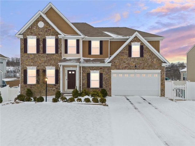 view of front of property with a garage, stone siding, fence, and board and batten siding