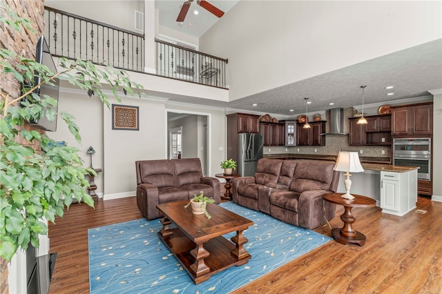 living room with crown molding, dark wood finished floors, and baseboards