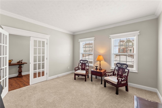 living area with baseboards, french doors, crown molding, a textured ceiling, and carpet floors