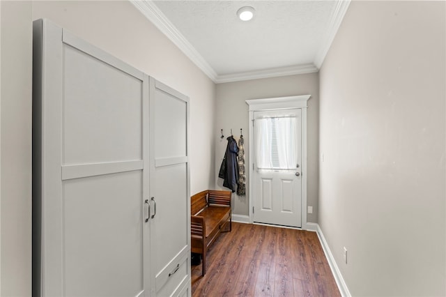 mudroom featuring dark wood-type flooring, crown molding, a textured ceiling, and baseboards