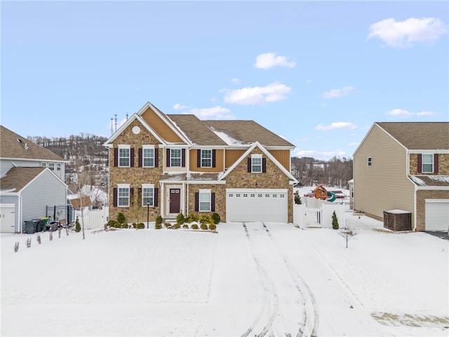 view of front of home featuring an attached garage, fence, and central AC unit