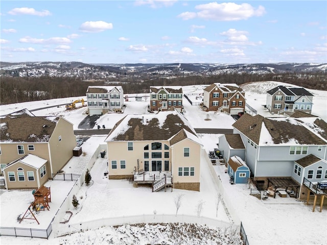 snowy aerial view with a residential view