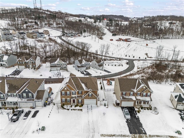 snowy aerial view featuring a residential view