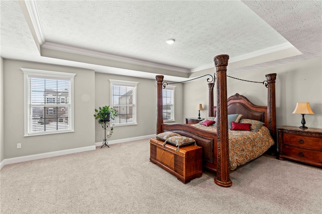 bedroom with light carpet, baseboards, a tray ceiling, and ornamental molding