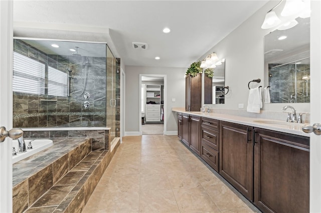 bathroom featuring double vanity, a garden tub, baseboards, and a sink