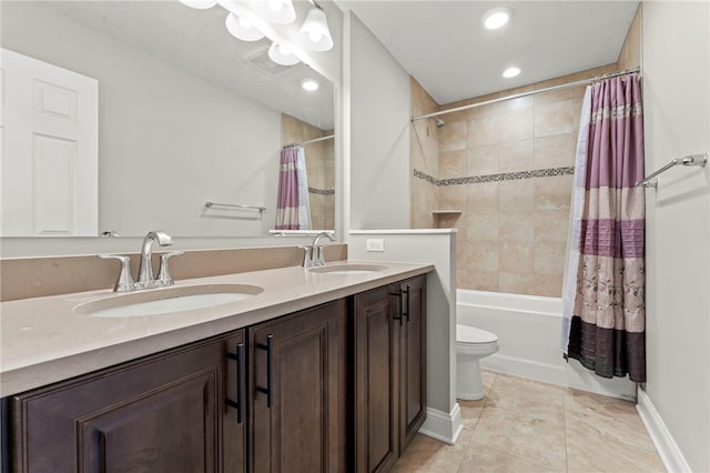 bathroom with double vanity, shower / bath combo, a sink, and toilet