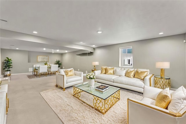 carpeted living room featuring baseboards and recessed lighting