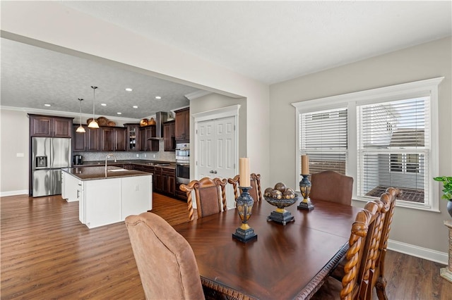 dining room featuring crown molding, baseboards, dark wood-type flooring, and recessed lighting