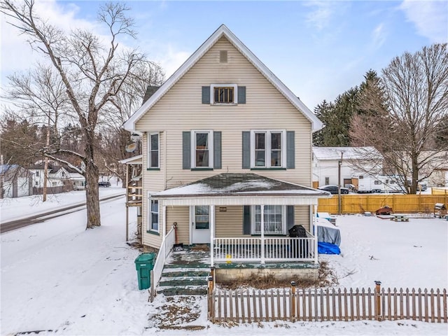 view of front of home with a fenced front yard and a porch