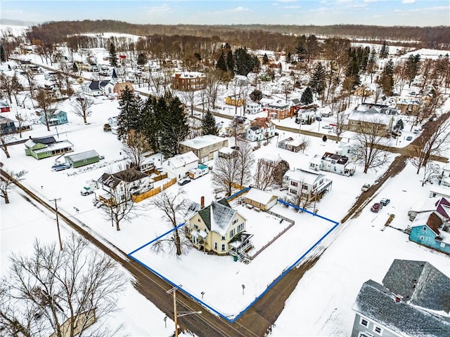 snowy aerial view with a residential view