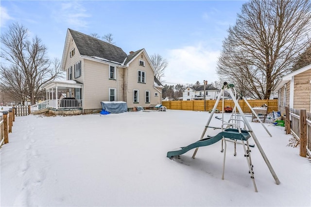 exterior space featuring a fenced backyard and a playground