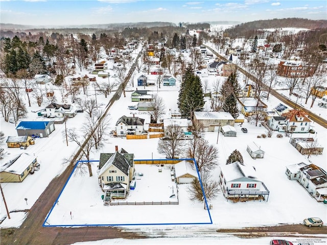 snowy aerial view featuring a residential view