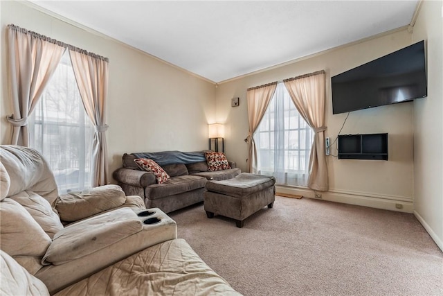 living room featuring ornamental molding, carpet flooring, and baseboards