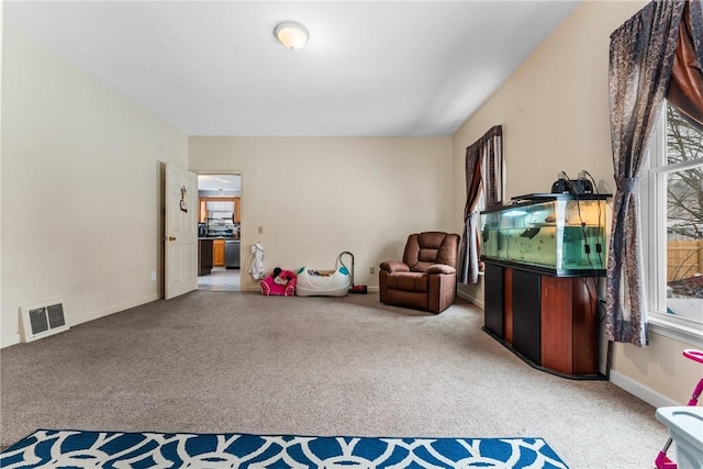 living area featuring light carpet, baseboards, and visible vents