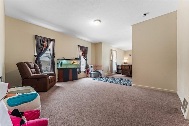 sitting room featuring carpet flooring, visible vents, and baseboards