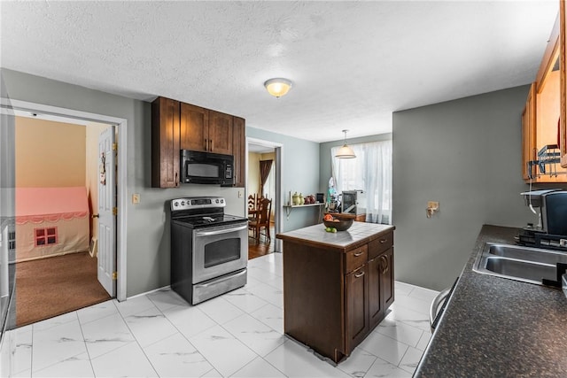 kitchen with black microwave, marble finish floor, stainless steel electric range oven, dark countertops, and decorative light fixtures