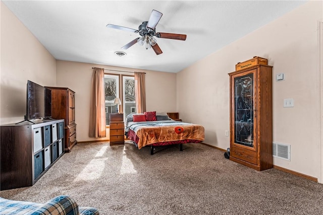 carpeted bedroom with a ceiling fan, visible vents, and baseboards