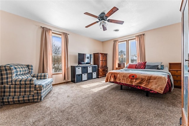 bedroom with ceiling fan, carpet, visible vents, and baseboards